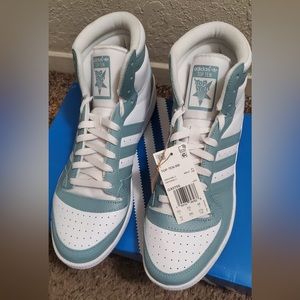 Baby blue and white high top adidas